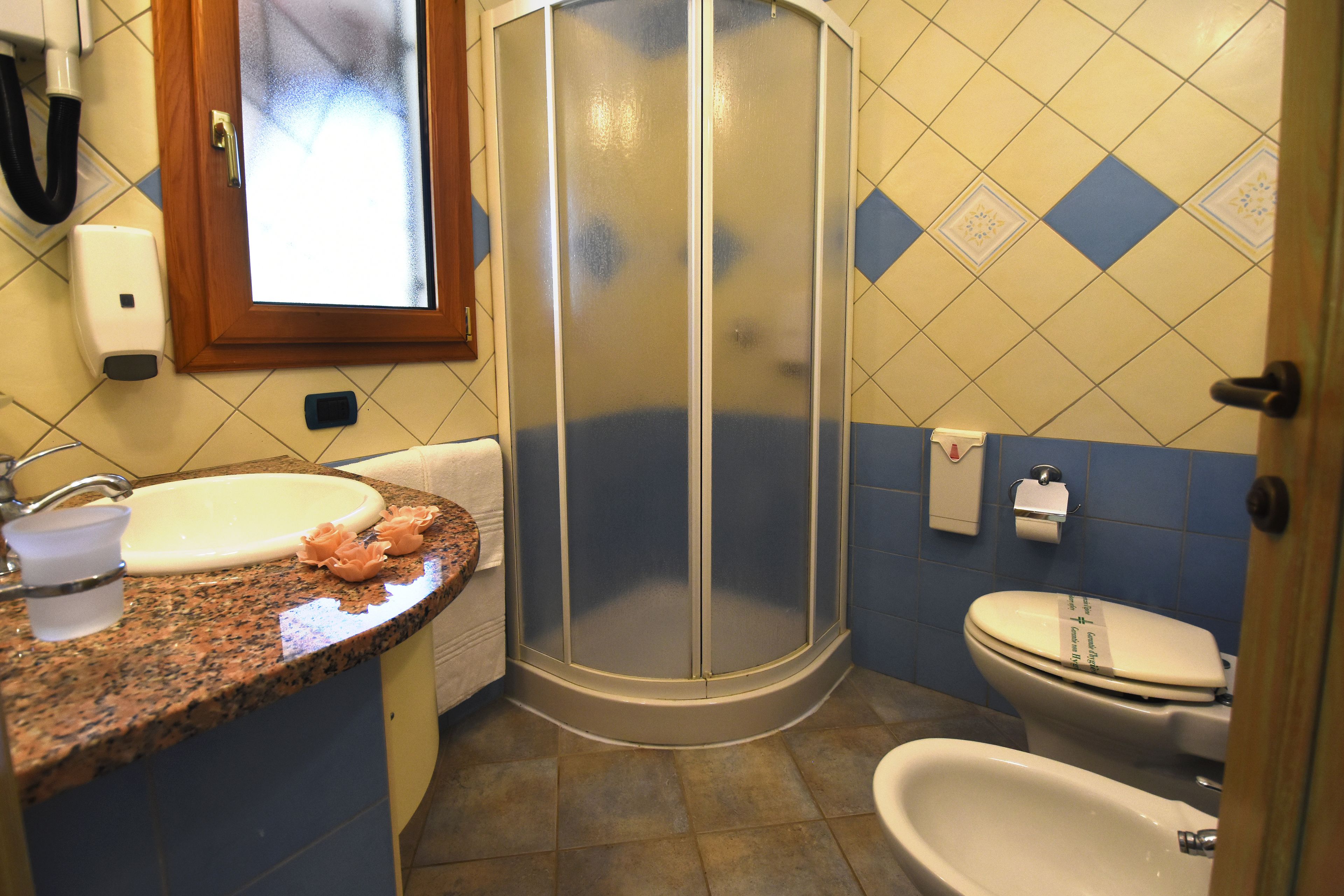 Un baño con ducha, lavabo e inodoro.