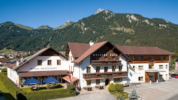 Experience the charm of the Golden Rose, where a traditional Alpine-style balcony offers breathtaking views of the surrounding mountains.