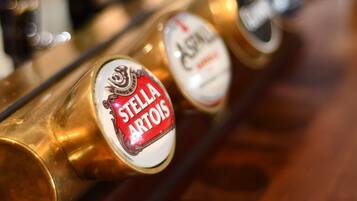 Una hilera de grifos de cerveza con etiquetas, incluyendo uno de Stella Artois.