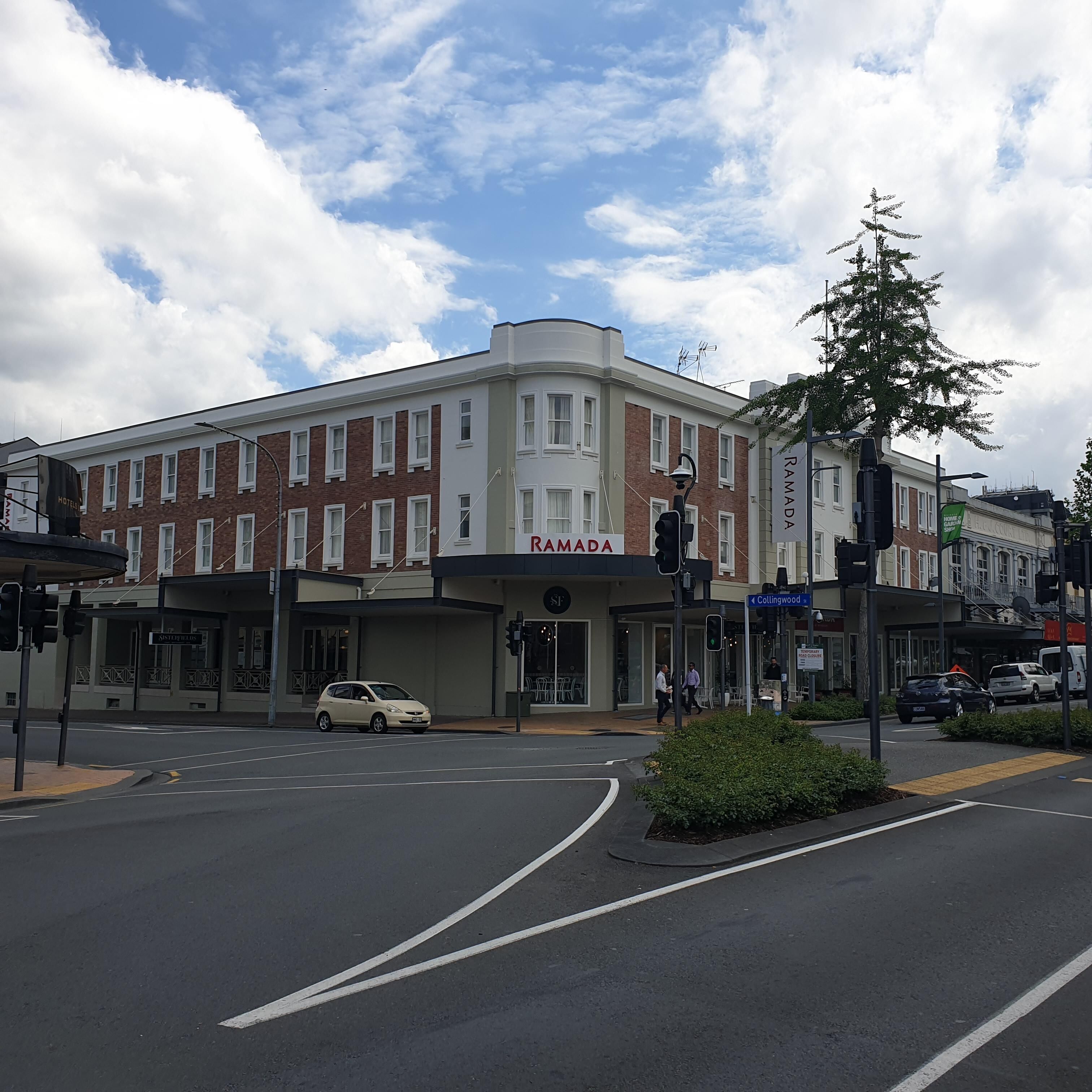 A corner building with a sign reading "RAMADA".