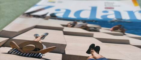 A magazine on a bed with a pillow and a blanket.