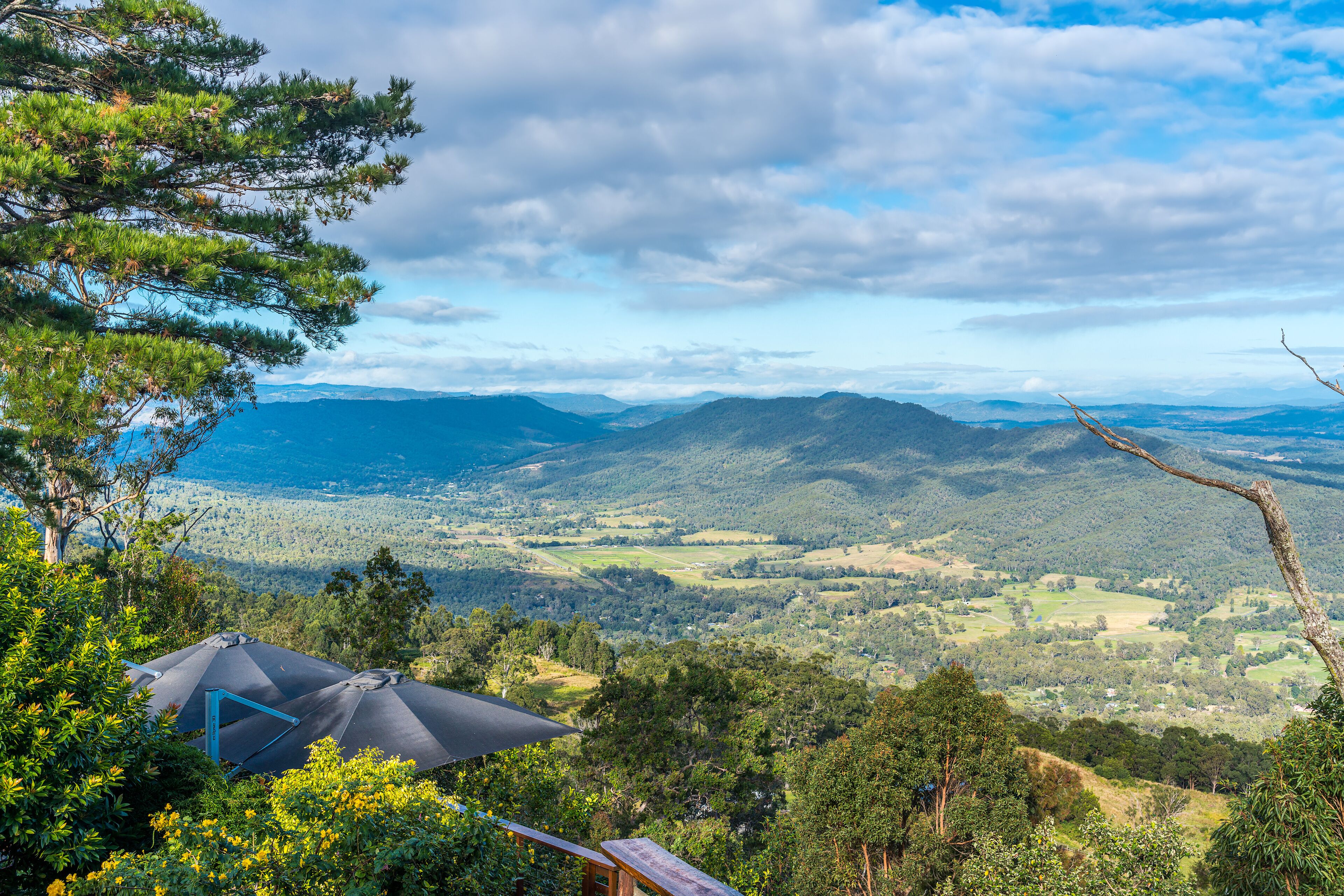A tented accommodation with a panoramic view of a mountainous landscape.