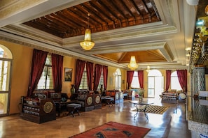 A spacious lobby with ornate wooden ceilings, large chandeliers, and traditional furnishings. - Hôtel Saghro (Tinghir)