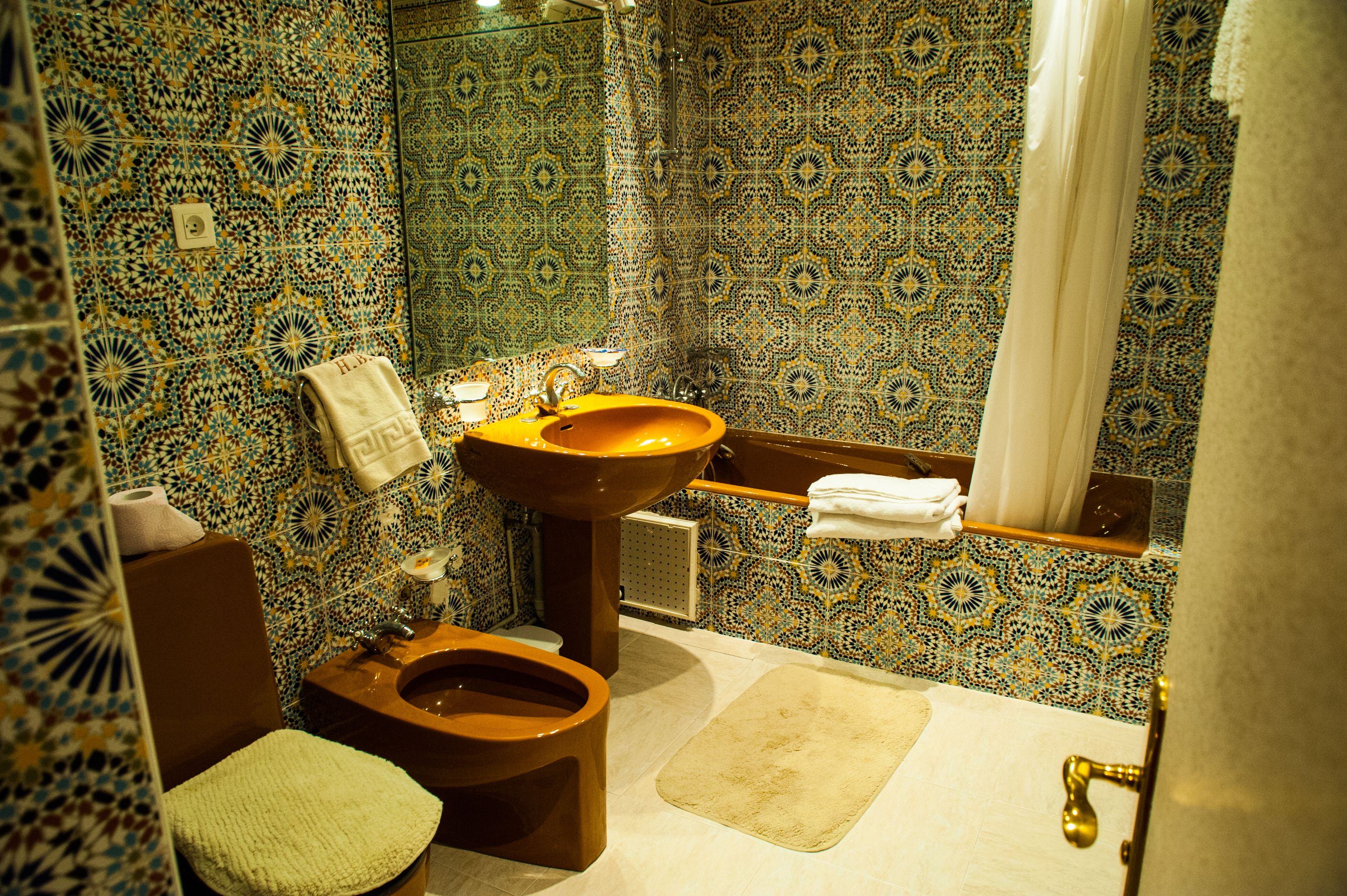 Casa de banho com design tradicional, com sanita, lavatório e área de duche.