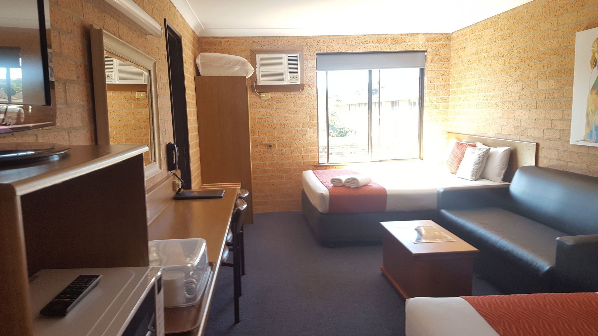 Premium bedding, desk, laptop workspace, blackout drapes