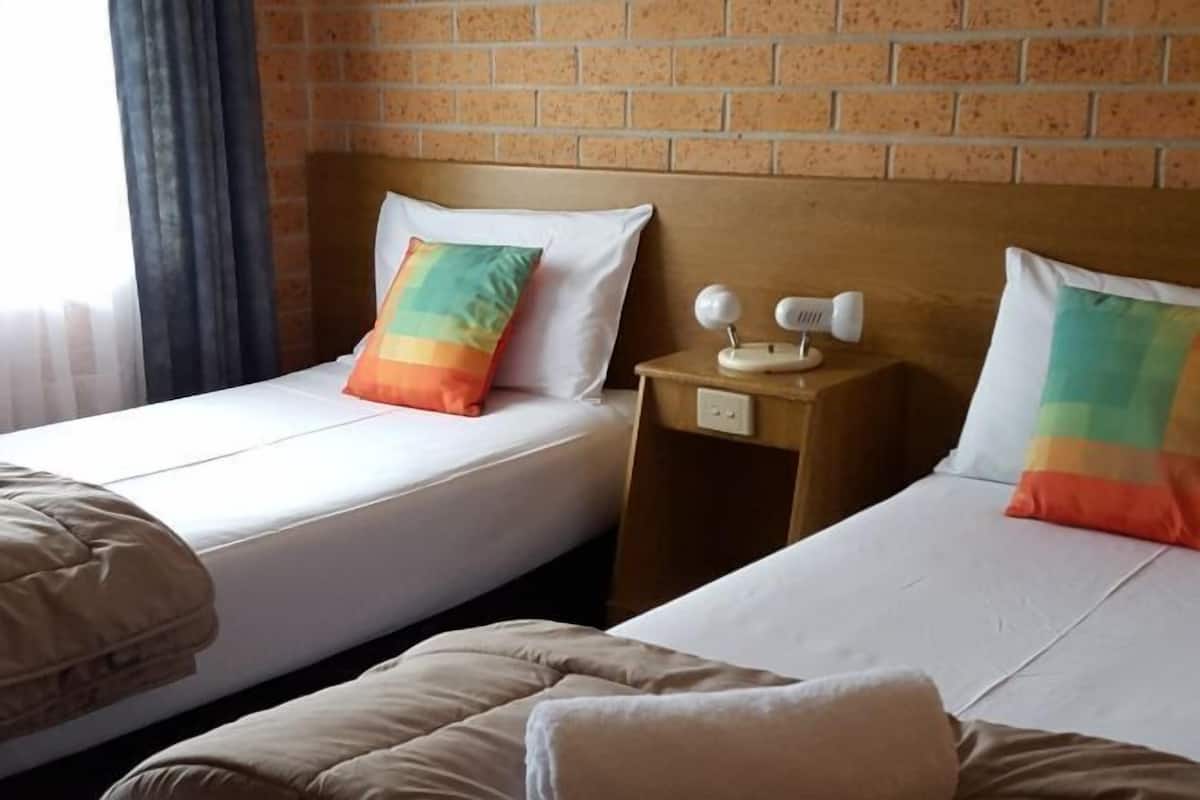 Premium bedding, desk, laptop workspace, blackout drapes
