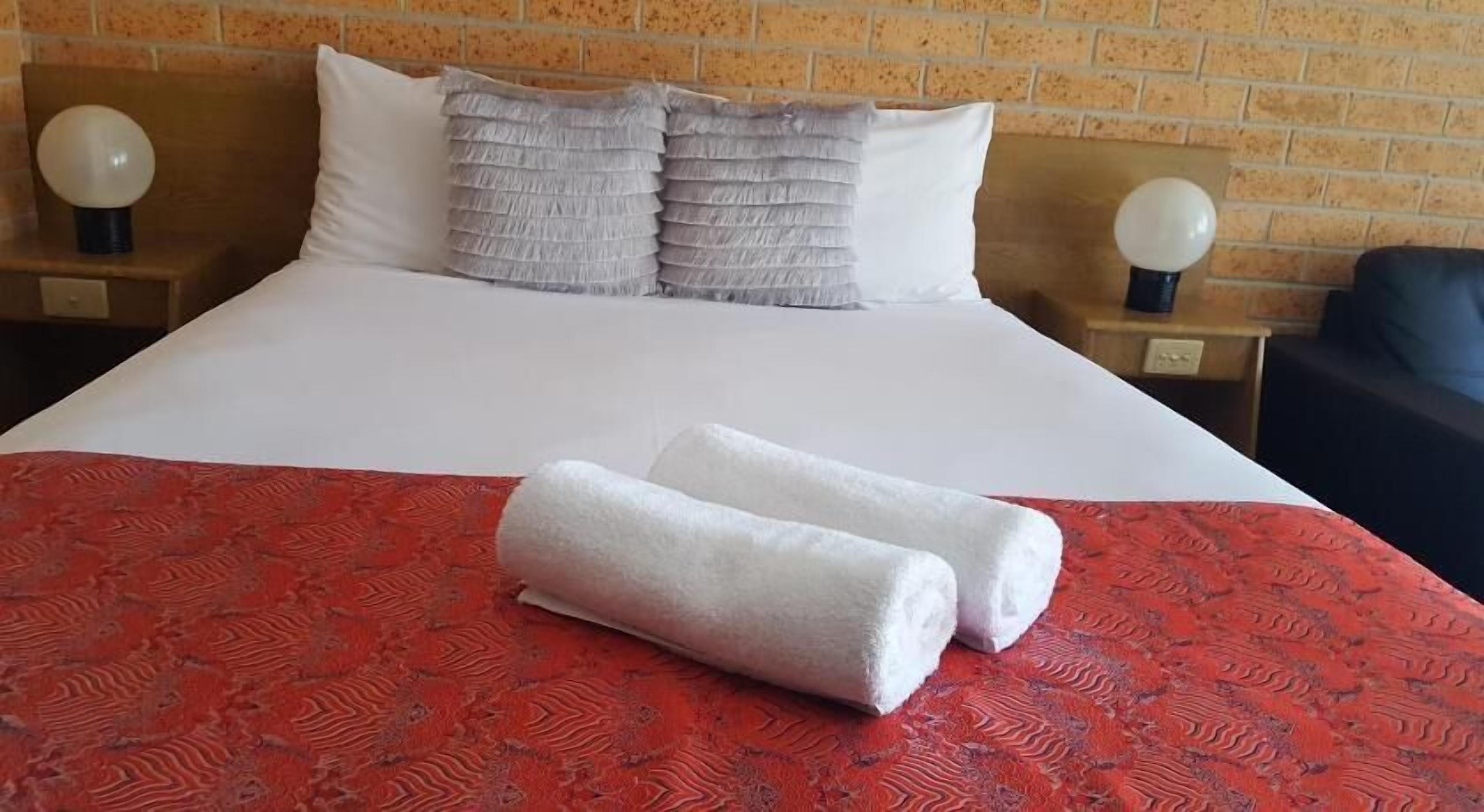 Premium bedding, desk, laptop workspace, blackout drapes