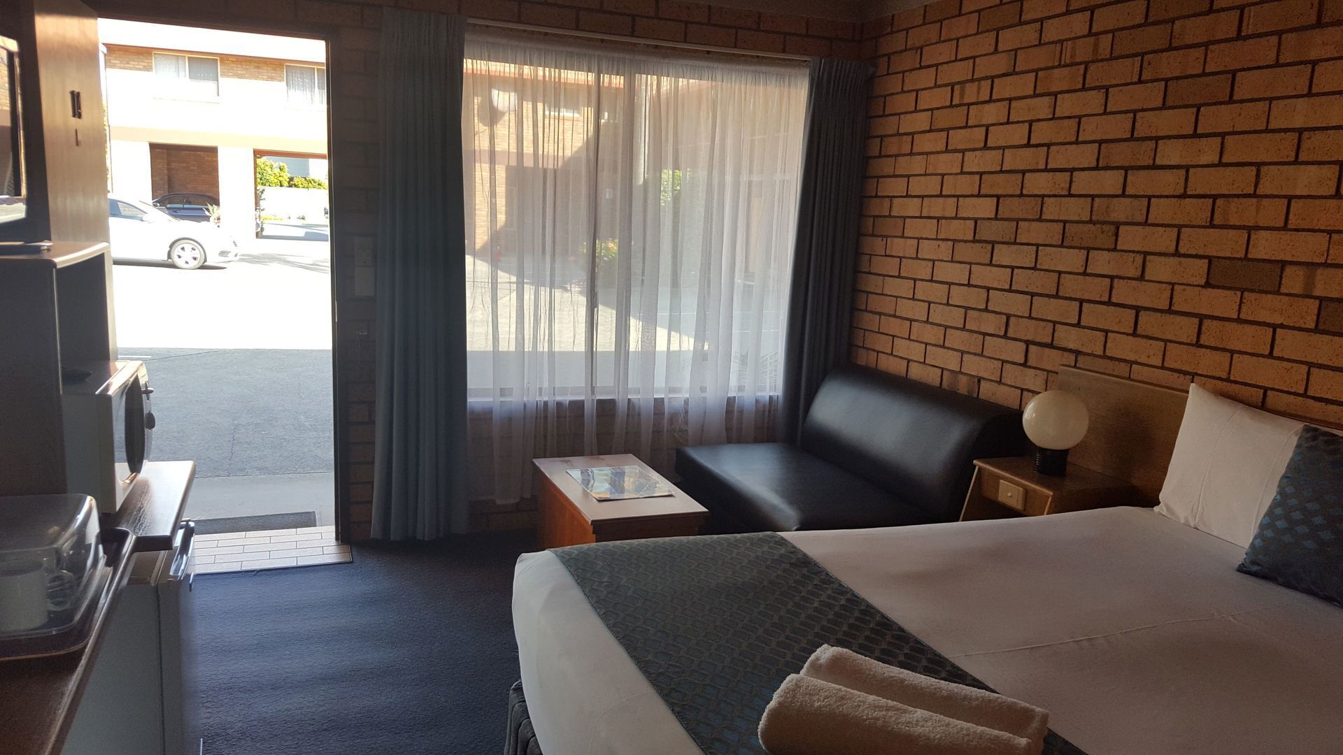 Premium bedding, desk, laptop workspace, blackout drapes