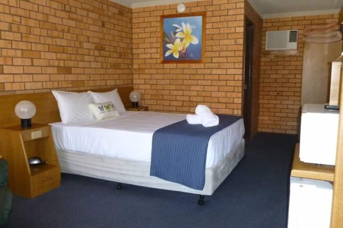 Premium bedding, desk, laptop workspace, blackout drapes