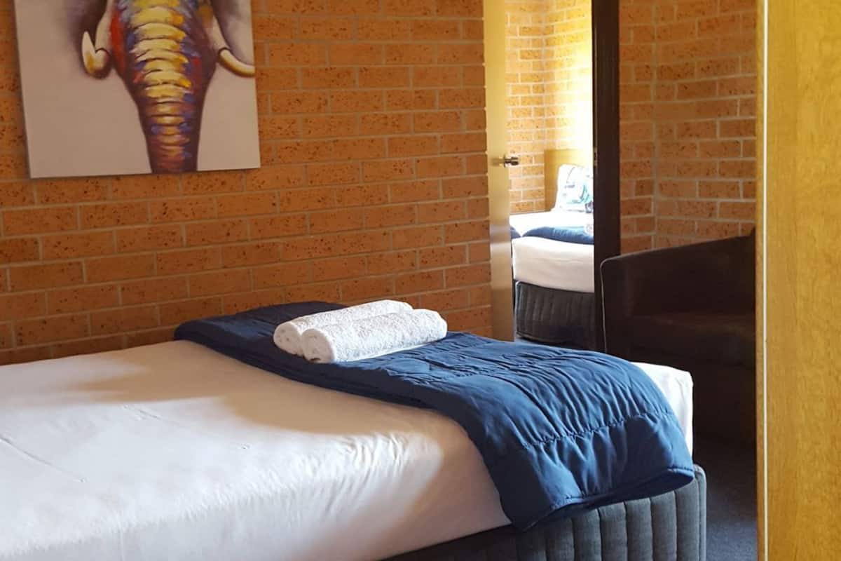 Premium bedding, desk, laptop workspace, blackout drapes