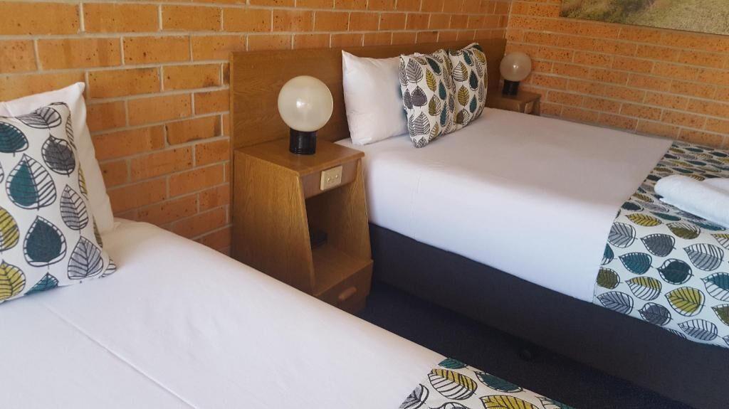 Premium bedding, desk, laptop workspace, blackout drapes