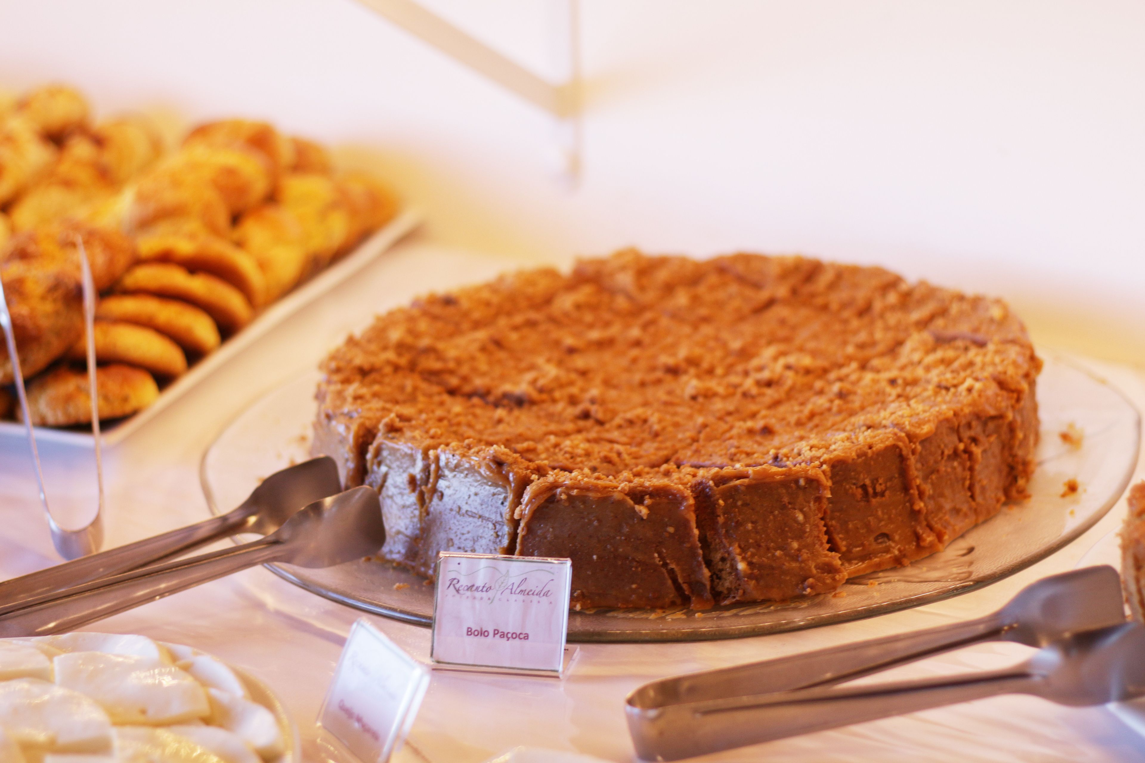A dessert display with a chocolate cake and other pastries.