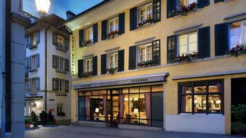 Hotel Schwab offers a charming European facade with a restaurant and entrance under a canopy.