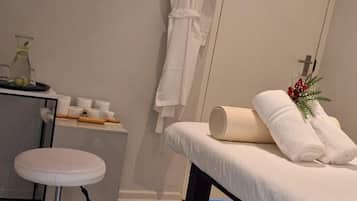 Relax in comfort with a massage table, desk, and cozy seating area.