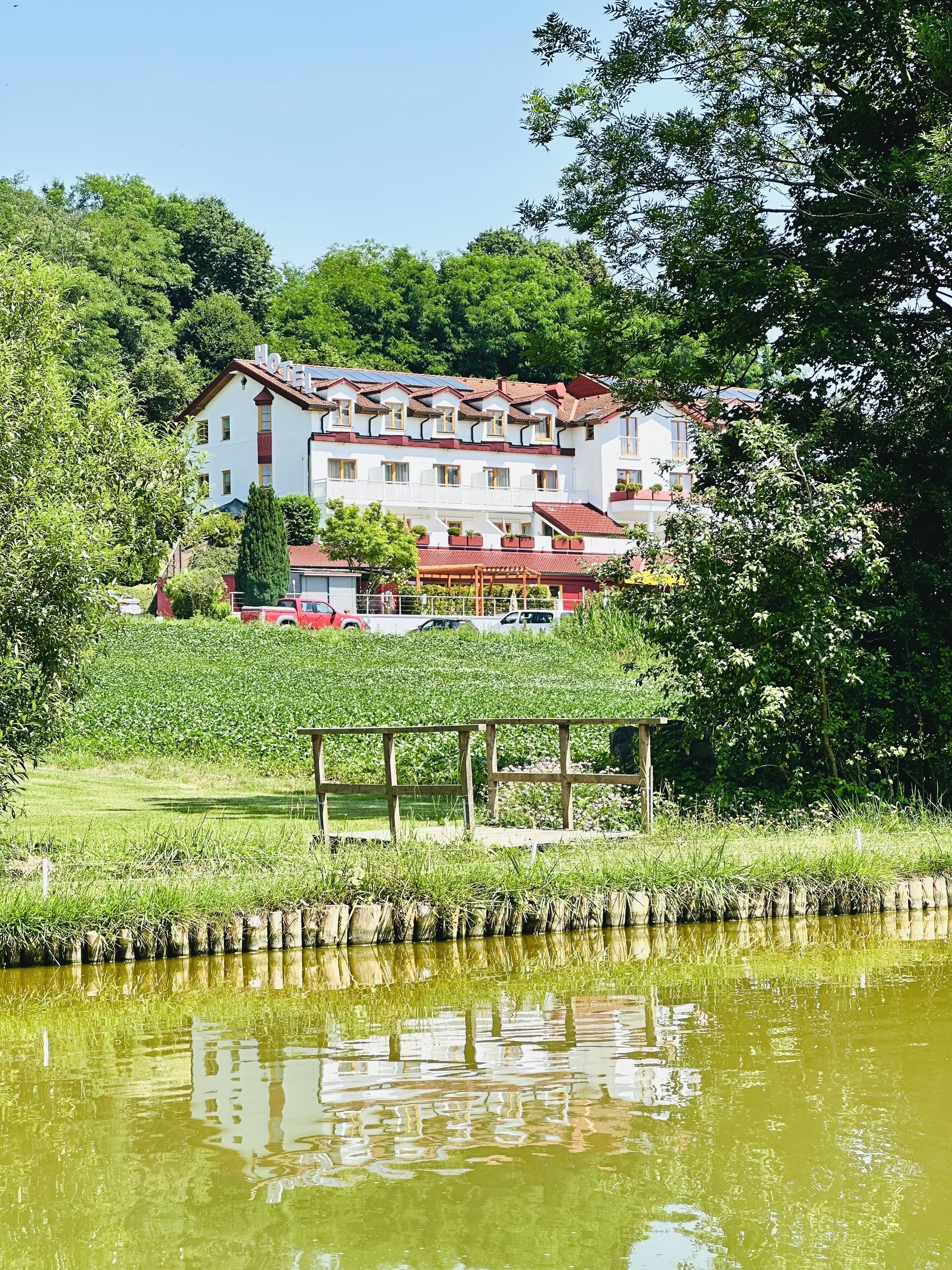 A hotel with multiple floors, balconies, and a red roof.
