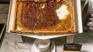 Een honingraatdessert op een witte standaard met een bordje waarop staat 'Honey Wabe'.