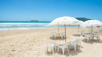 On the beach, sun-loungers, beach umbrellas