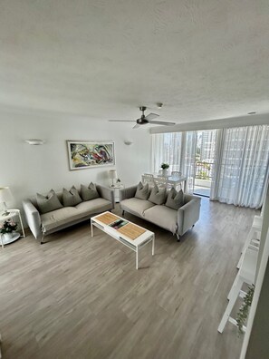 A modern living room with a sofa, a coffee table, and a ceiling fan. - Pacific Resort Broadbeach (Broadbeach)