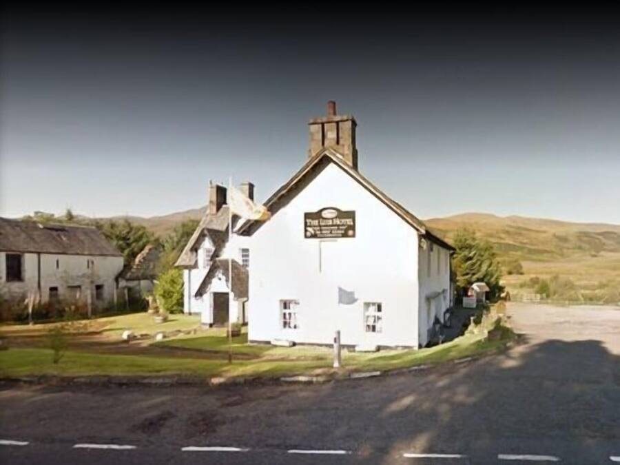 A white building with a sign reading "The Old Inn."