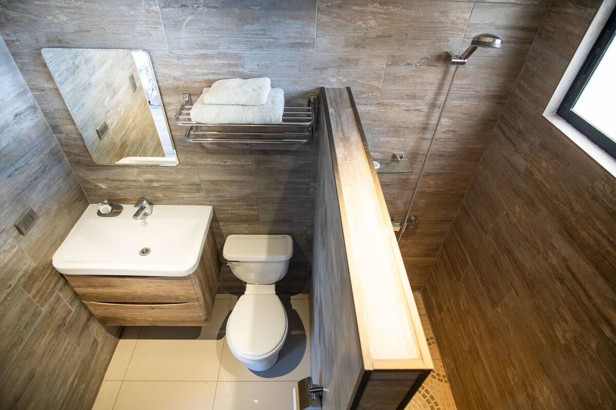 shower, rainfall showerhead, hair dryer, towels