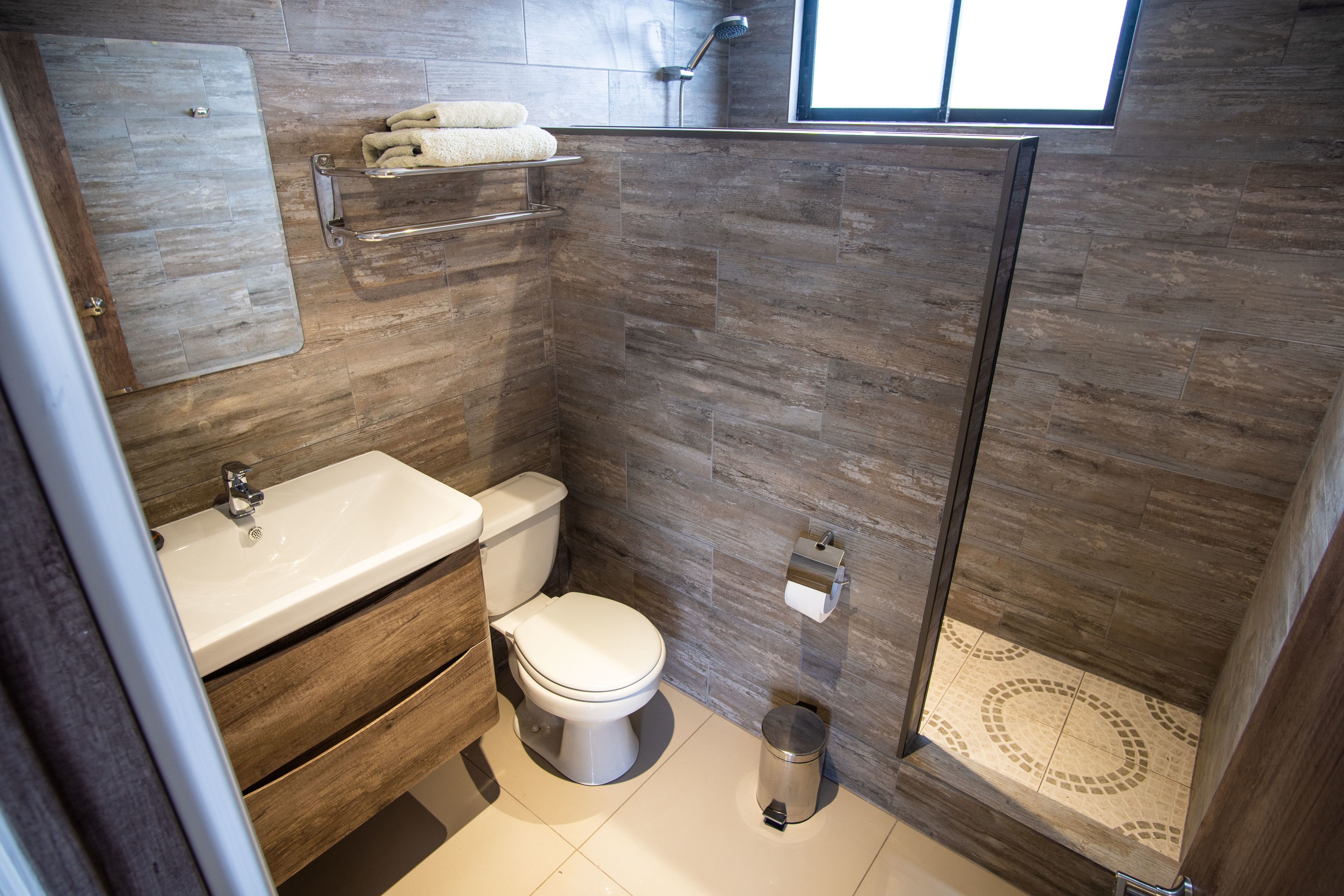 shower, rainfall showerhead, hair dryer, towels