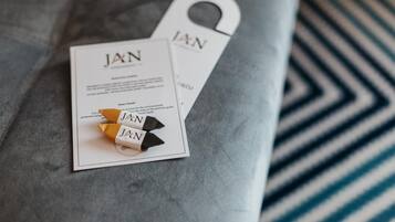 A tag with the name "JAN" on a grey surface.