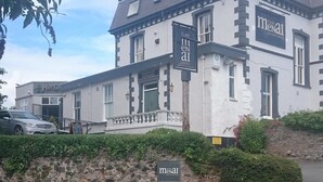 A building with a sign reading "The Medal Pub and Dining." - The Menai Hotel and Bar (Bangor)