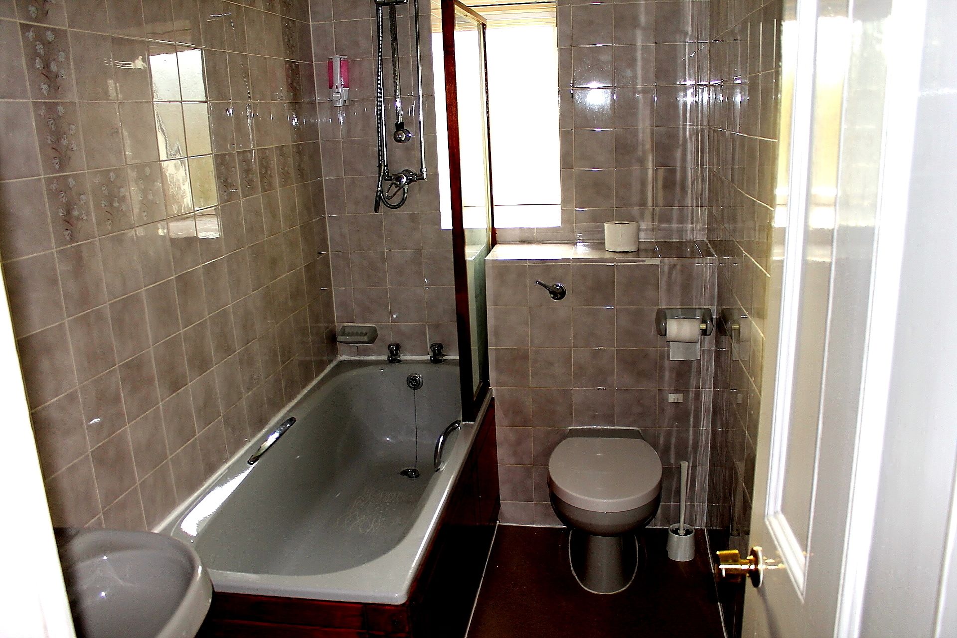 A bathroom with a bathtub, toilet, and a shower.