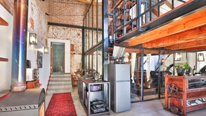 A kitchen with a stainless steel stove, a refrigerator, and a wooden table with a plant. - Valley of the Rainbow Fly Fishing Estate (Dullstroom)