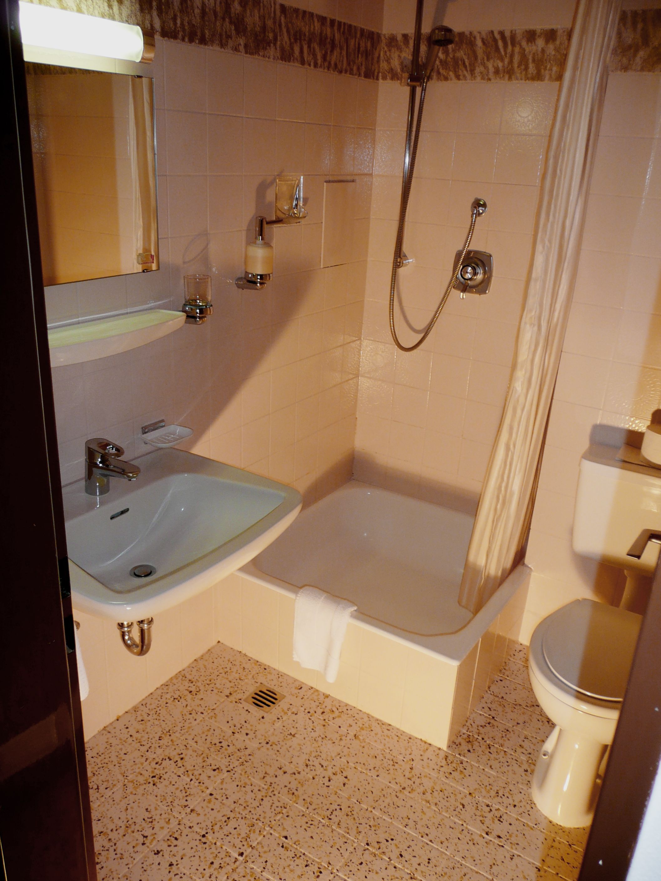 A bathroom with a sink, bathtub, toilet, and shower.