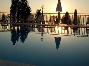Outdoor pool, open 9:00 AM to 7:00 PM, pool umbrellas, pool loungers