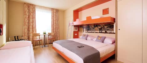 A bedroom with a bunk bed, a desk, and a chair.