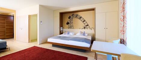 Quarto moderno com cama, escrivaninha e tapete vermelho.