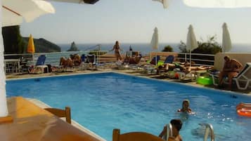 Seasonal outdoor pool, open 9:00 AM to midnight, pool umbrellas