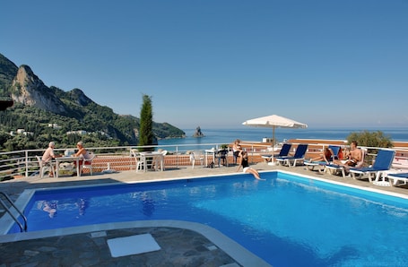 Seasonal outdoor pool, open 9:00 AM to midnight, pool umbrellas