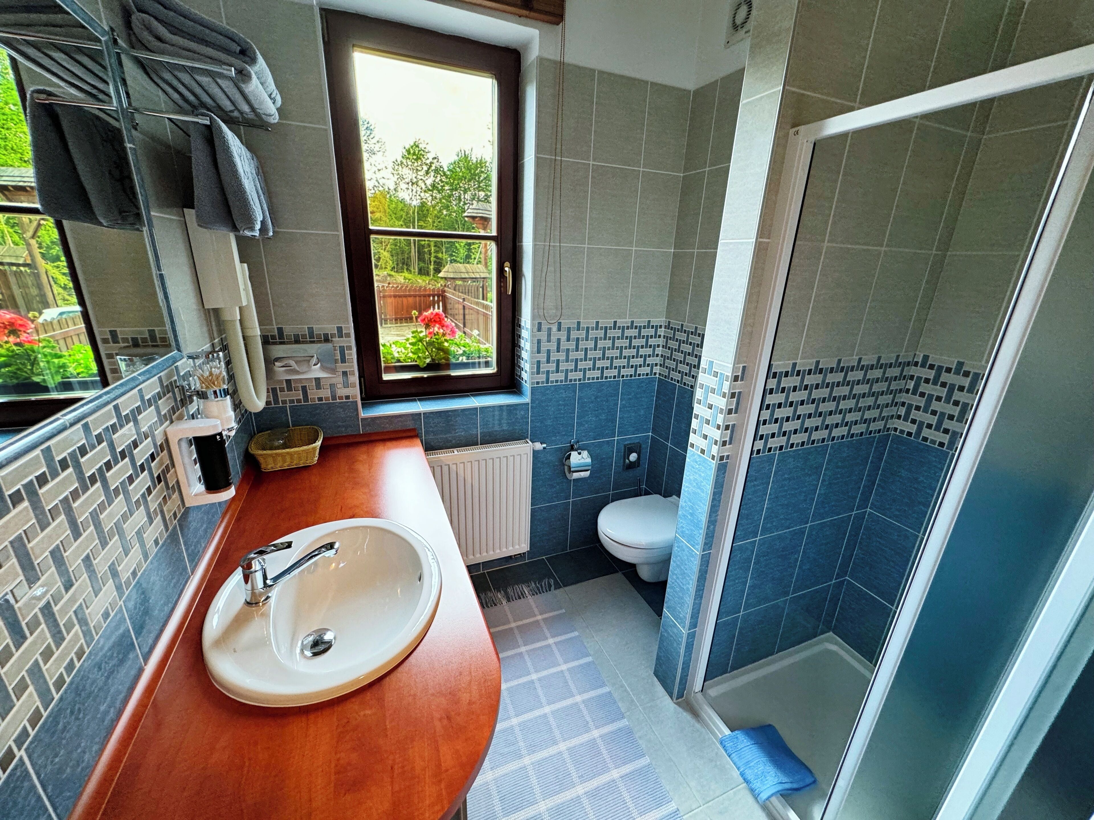 A bathroom with a sink, toilet, and shower.