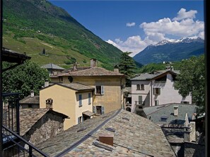 Experience the tranquility of a traditional European village, nestled among lush green hills and snow-capped mountains.