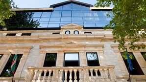 A building with classical architecture, featuring a prominent balcony with ornate balustrades and a large glass facade reflecting the sky. - EfBet Hotel (Varna)