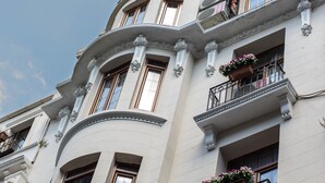 A multi-story building with classical architectural features, including ornate balconies and decorative moldings.