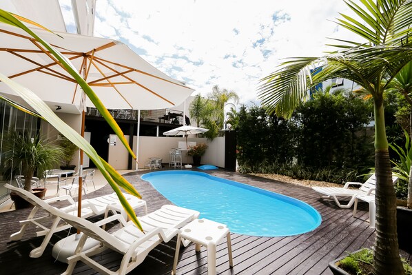 Outdoor pool, open 7:00 AM to 10:00 PM, pool loungers