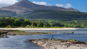 A mountain landscape with a beach and forest. - The Douglas Hotel (Isle of Arran)