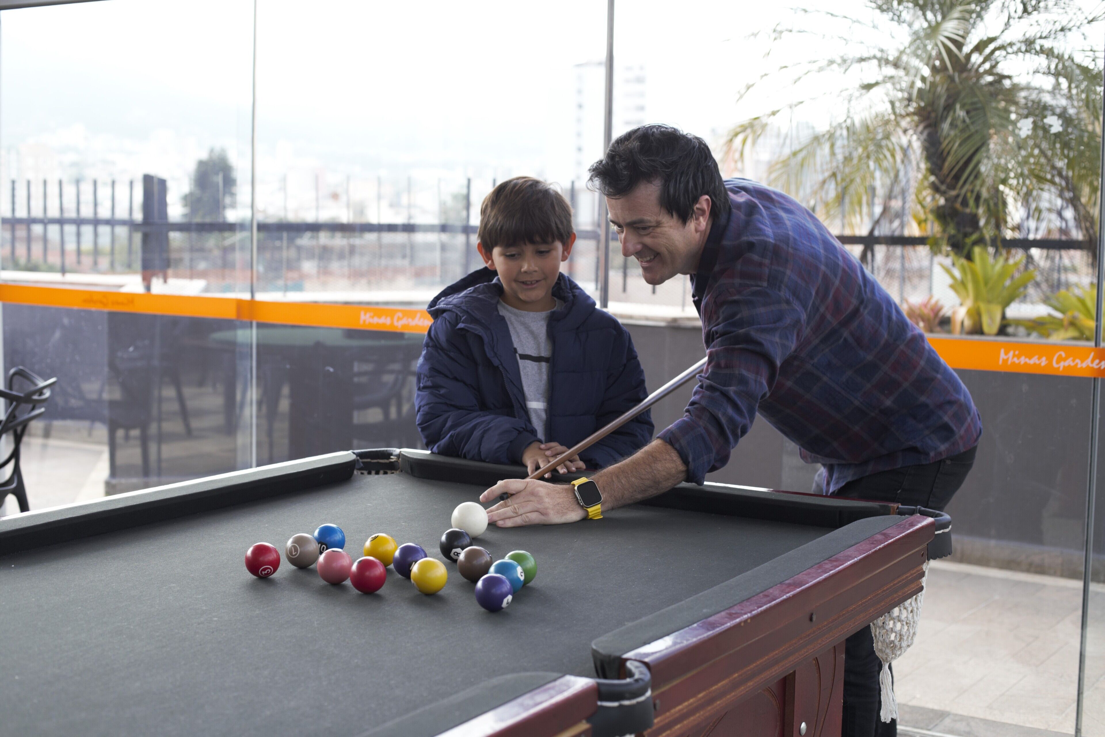 A pool table with balls and a person playing.