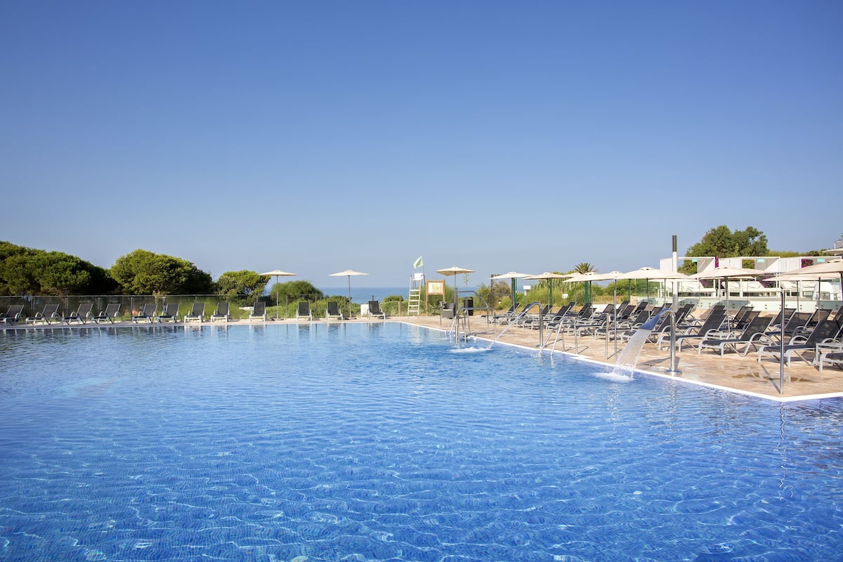 indoor pool, outdoor pool, pool umbrellas, pool loungers