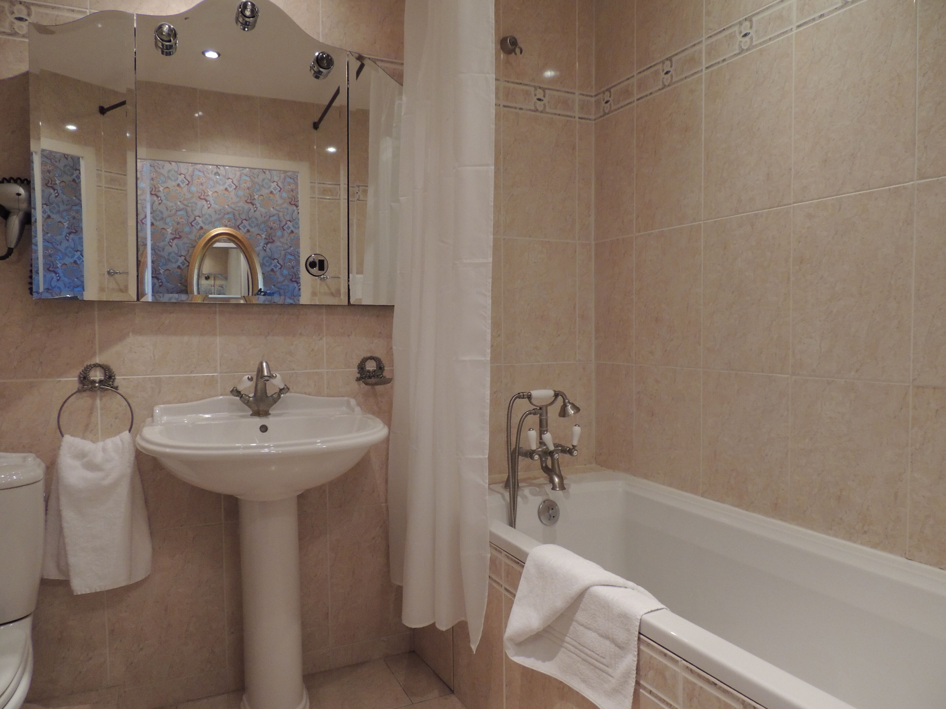 A bathroom with a sink, toilet, and bathtub.