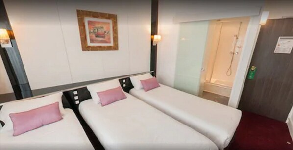 A hotel room with two single beds, a shower area, and a framed picture on the wall. - Hôtel du Trosy Clamart (Clamart)