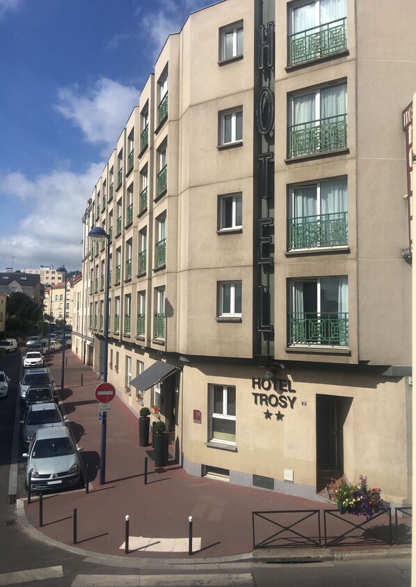 A hotel named 'HOTEL TROSY' with a sign indicating a 'No Entry' for vehicles. The building has multiple floors with balconies, and there are parked cars along the street. - Hôtel du Trosy Clamart (Clamart)