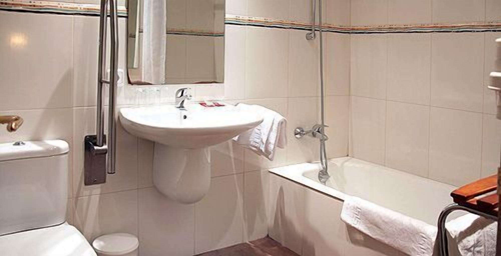 hair dryer, towels, shampoo, toilet paper