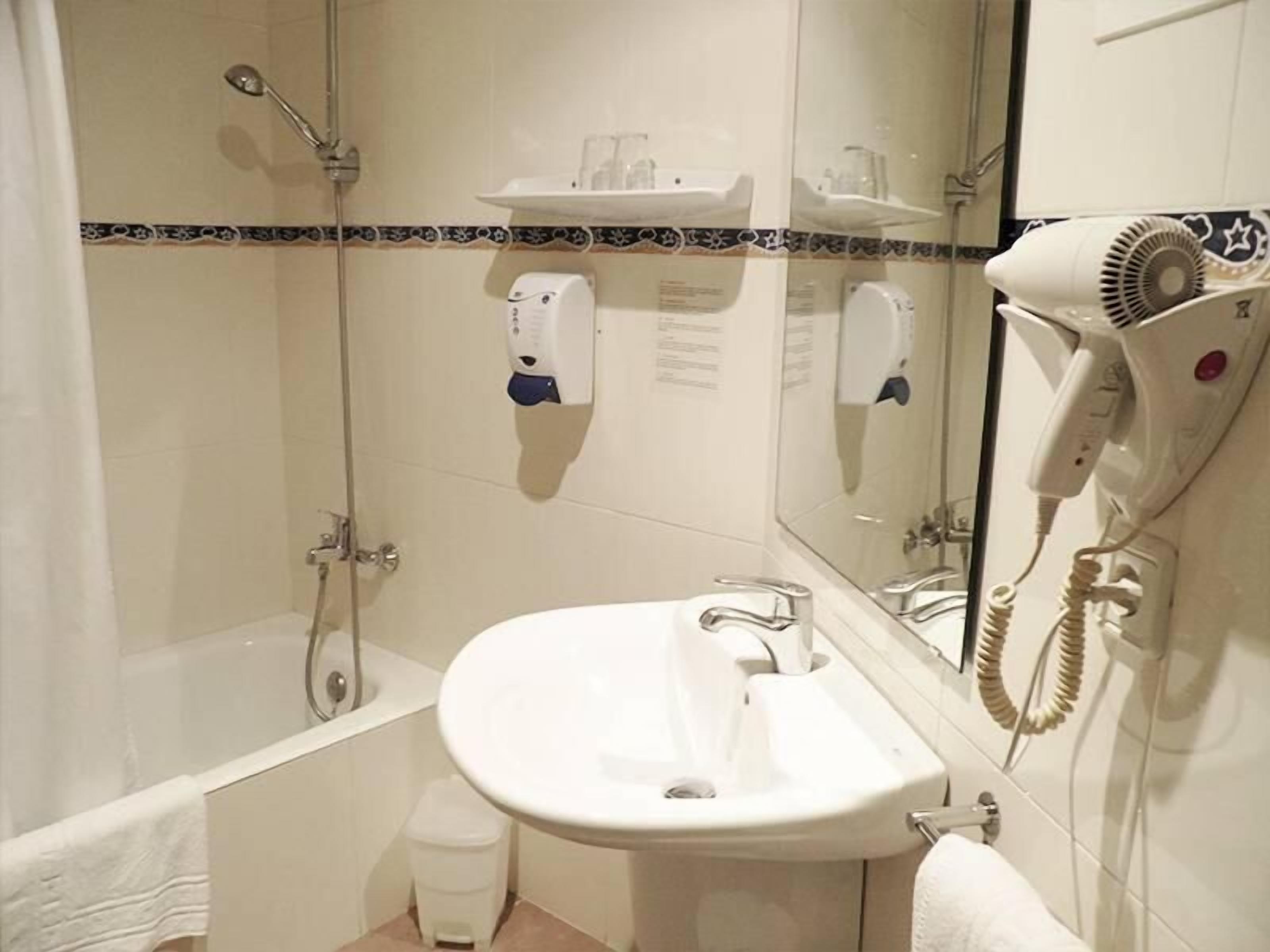 hair dryer, towels, shampoo, toilet paper