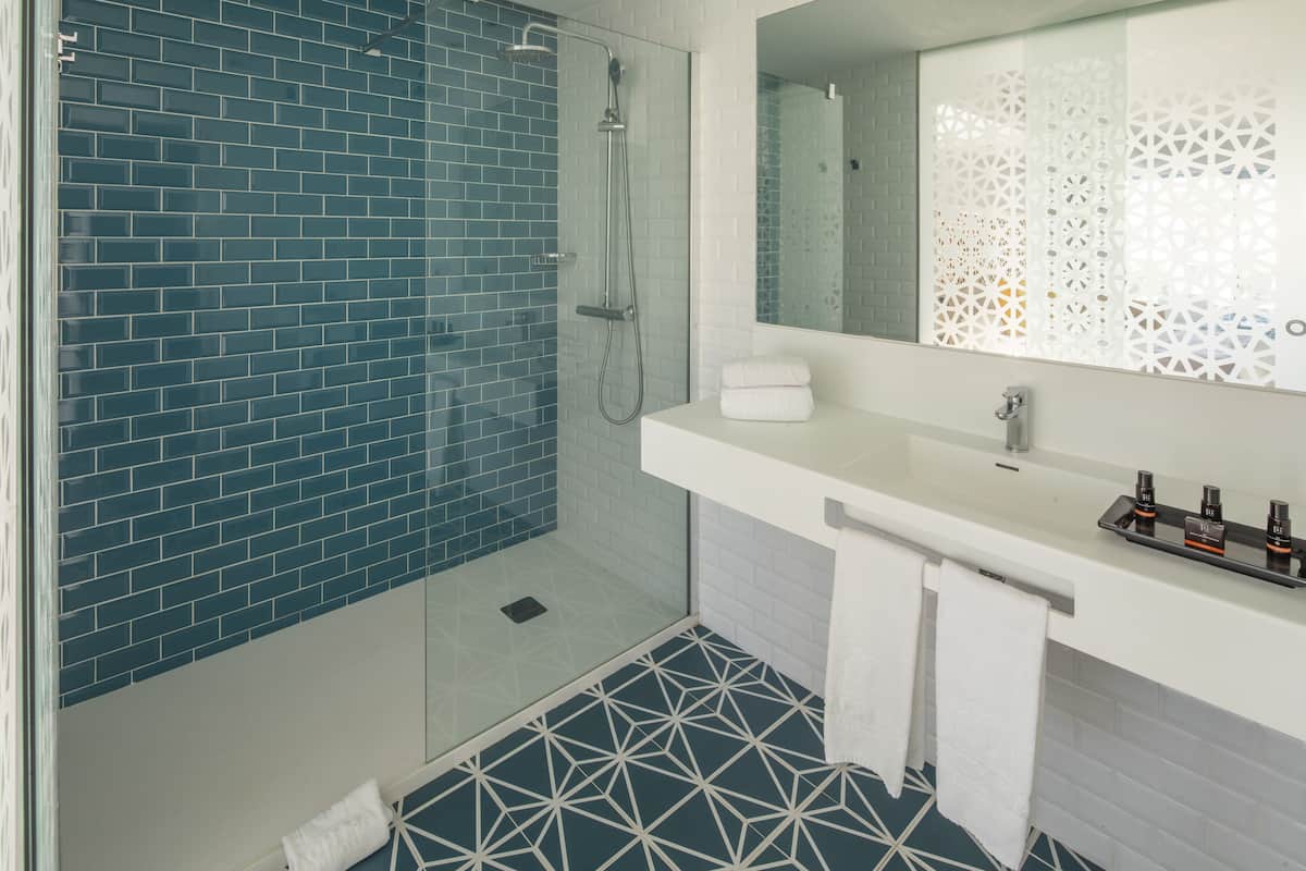 shower, rainfall showerhead, hair dryer, towels