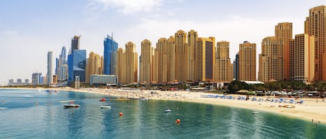 Beach nearby, white sand, beach umbrellas, beach towels